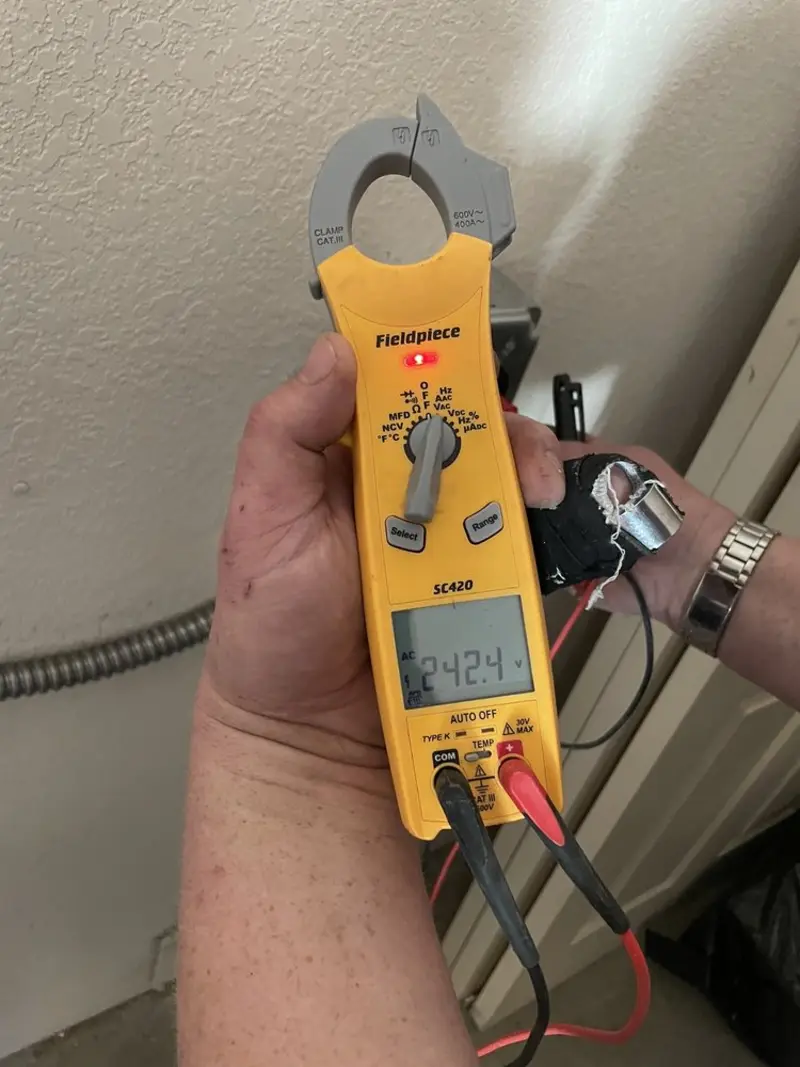Voltage testing with clamp meter during Ceiling Fan Installation in Silver Creek